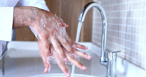 Man washing hands properly with soap to be protected for Coronavirus 2019-nCoV pandemic epidemic infection. Doctor shows how to wash hands properly.