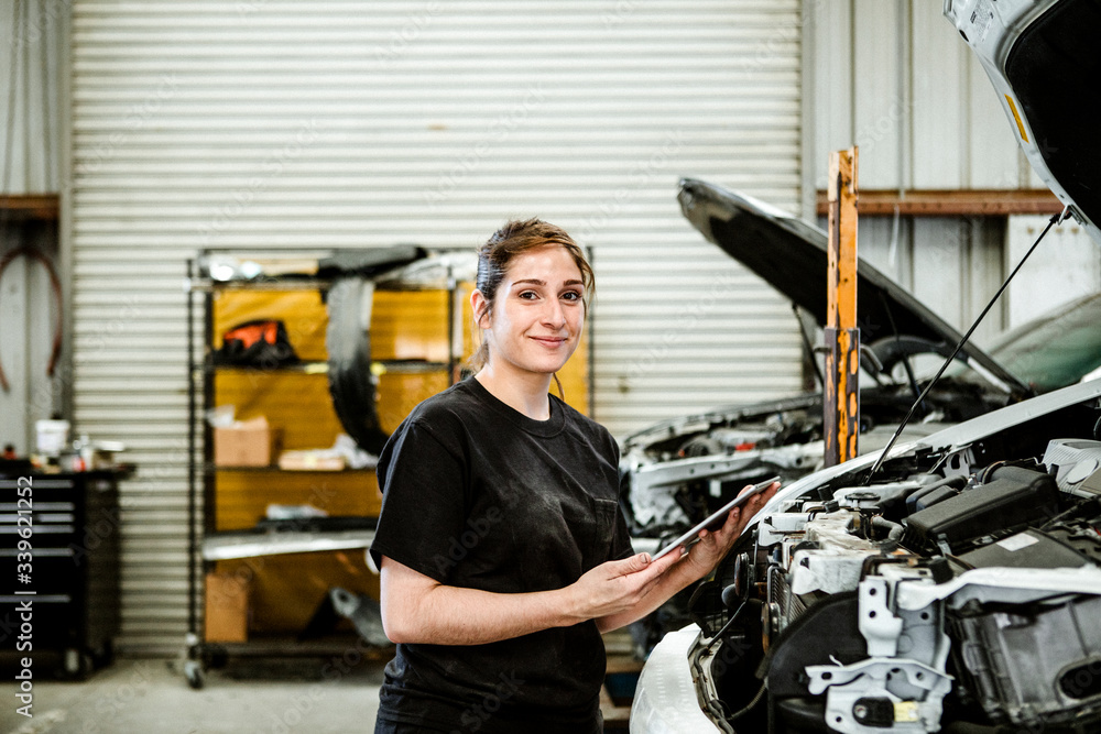 Happy female car mechanic