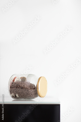 Small stones and sea shells in a bottle. Vertical