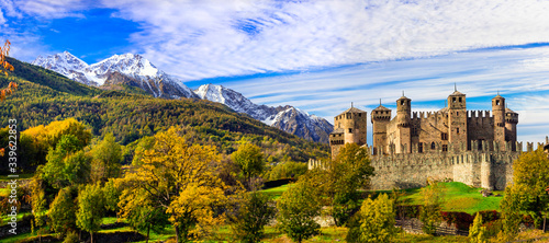 Medieval castles of Italy - beautiful Castello di Fenis in Valle d'Aosta surrounded by Alps mountains photo