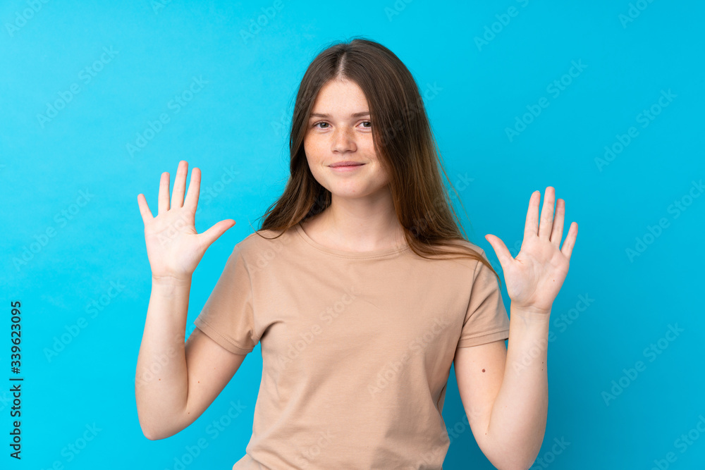 Ukrainian teenager girl over isolated blue background counting ten with fingers Ukrainian teenager girl over isolated blue background counting ten with fingers