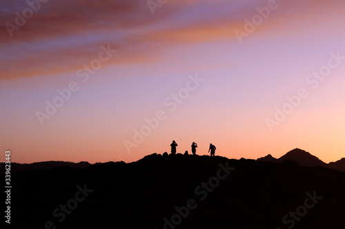 Turists taking pictures at sunset