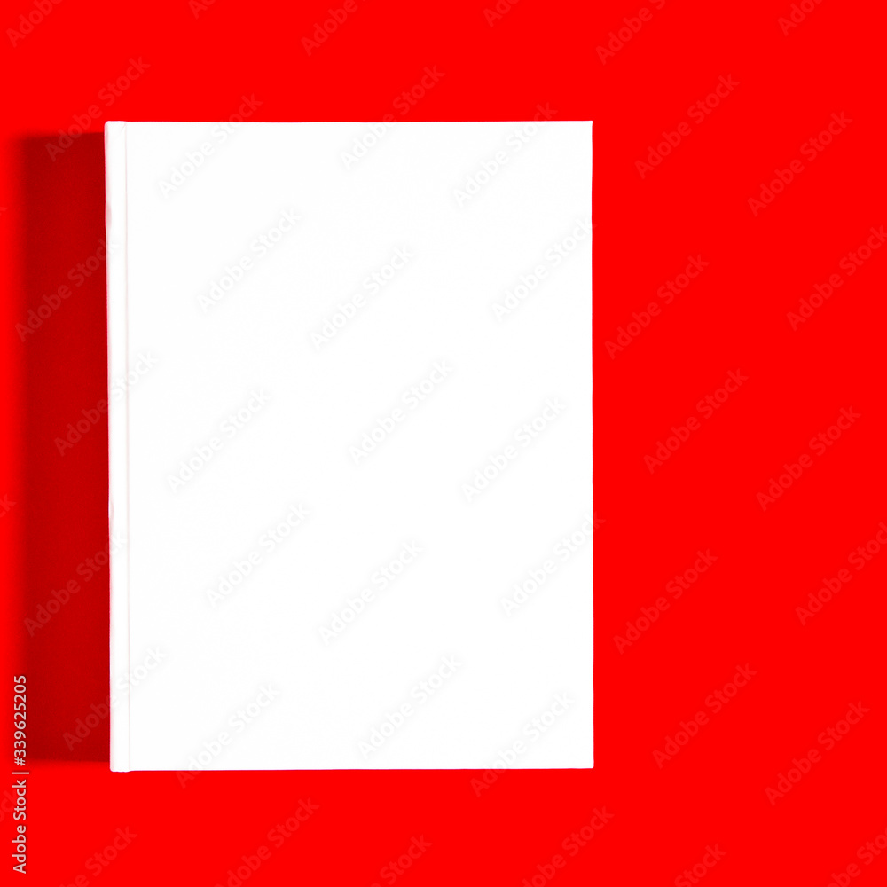 Mockup of closed blank square book at white textured paper Mockup of closed blank square book at white textured paper