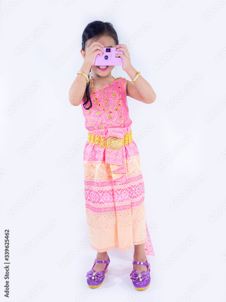 children girl in pink Thai dress Taking pictures by film camera on white background children girl in pink Thai dress Taking pictures by film camera on white background