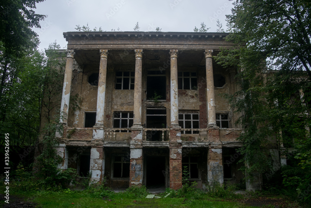 Front view of old abandoned mansion building facade. Vintage historical architecture ruins. Destruction of old building. Front view of old abandoned mansion building facade. Vintage historical architecture ruins. Destruction of old building.