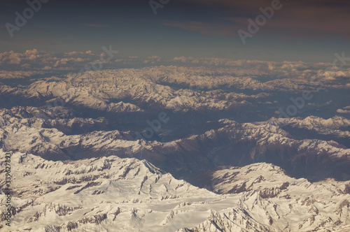 Snow-capped peaks and valleys of the Alps seen from the plane © Gianluca