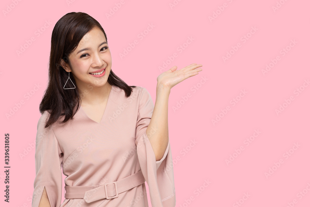 Happy Asian woman presenting or showing open hand palm with copy space for product Happy Asian woman presenting or showing open hand palm with copy space for product