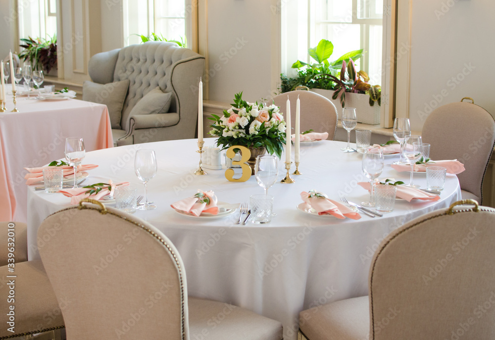 Table for wedding with white ang light pink flowers in restaraunt Table for wedding with white ang light pink flowers in restaraunt