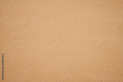 Brown embossed paper background. Laid paper pattern texture. Empty abstract background. Cardboard backdrop with copy space. Horizontal photo.