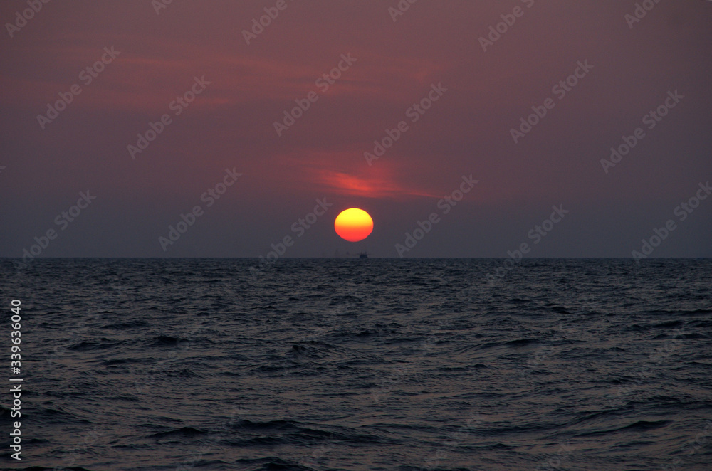 red sun at sunset over the sea