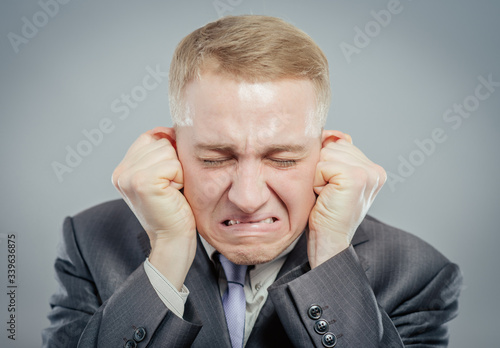 Portrait of a young businessman crying