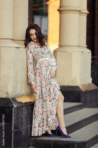 Beautiful girl walking on the street in spring. Young woman enjoying spring weather weather.
