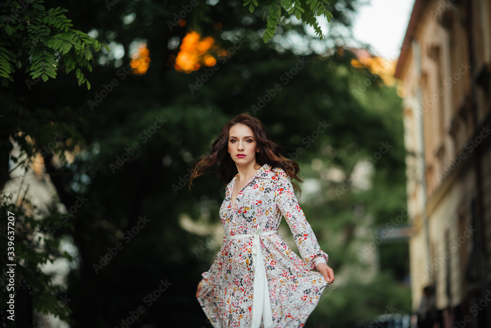 brunette walks through the streets of Lviv in a beautiful long dress brunette walks through the streets of Lviv in a beautiful long dress
