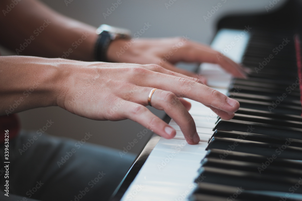 Obraz premium Detail of hands playing the piano