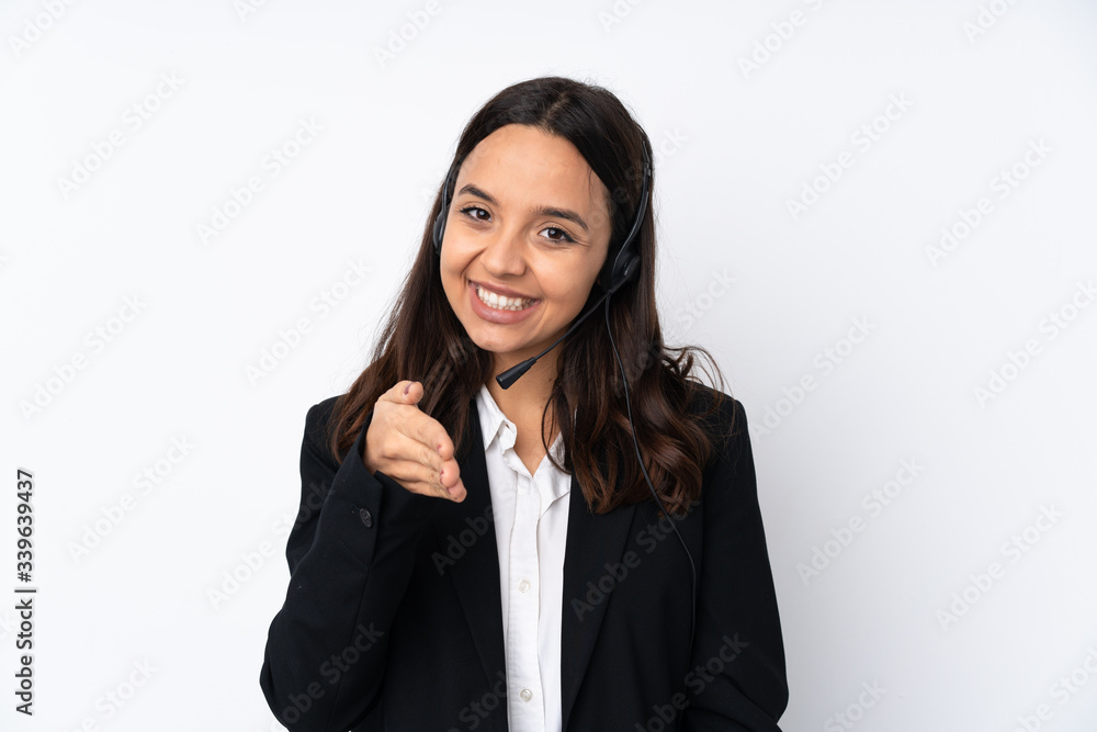 Young telemarketer woman isolated on white background shaking hands for closing a good deal Young telemarketer woman isolated on white background shaking hands for closing a good deal