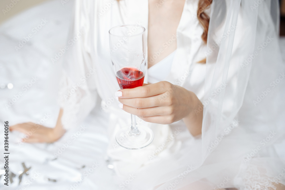 bride in a bathrobe holds a glass bride in a bathrobe holds a glass