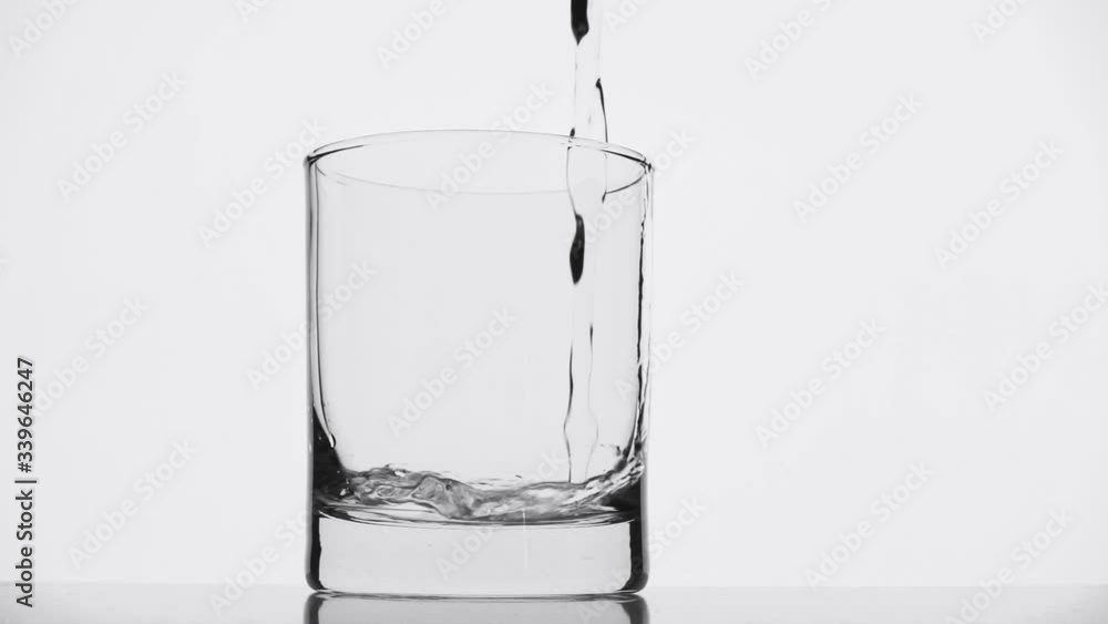 Pure water is poured into a glass. Slow motion Pure water is poured into a glass. Slow motion