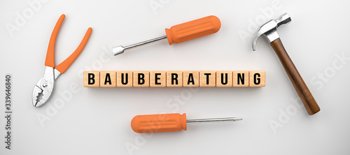 set of tools and cubes with German message for CONSTRUCTION CONSULTING on white background