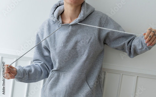 Model wearing gray hoodie photo