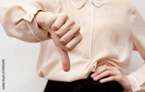 the business woman shows dislike. Thumbs down. Dislike symbol