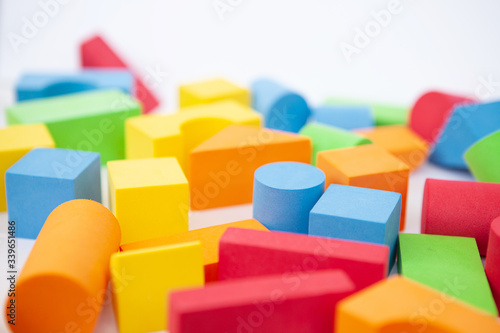 Bright multi-colored details of the designer. Children s toy on a white background. Background of colorful toy figures.