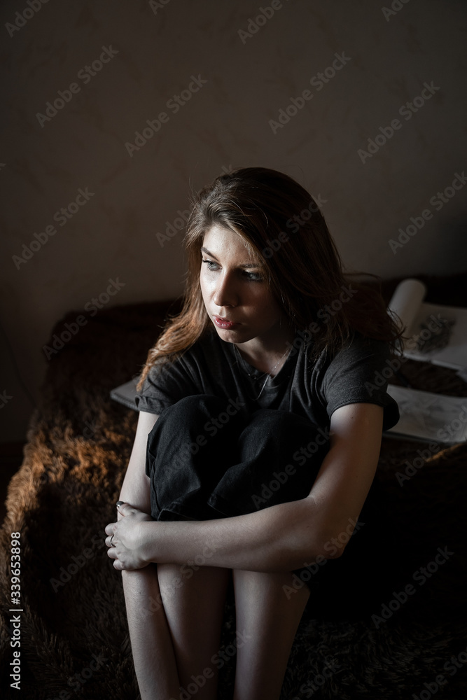 portrait of a girl with brown hair, sitting at home on the bed, look out the window portrait of a girl with brown hair, sitting at home on the bed, look out the window