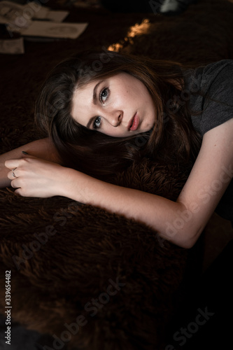 depressed girl portrait on bed with outstretched arms depressed