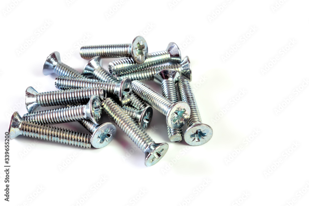 a pile of screws on an isolated background with space for text a pile of screws on an isolated background with space for text