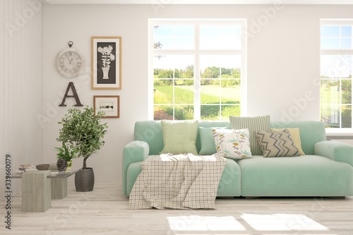 White living room with sofa and summer landscape in window. Scandinavian interior design. 3D illustration