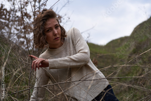 Beautiful girl in the canyon in the reeds, fashion shooting outdoors
