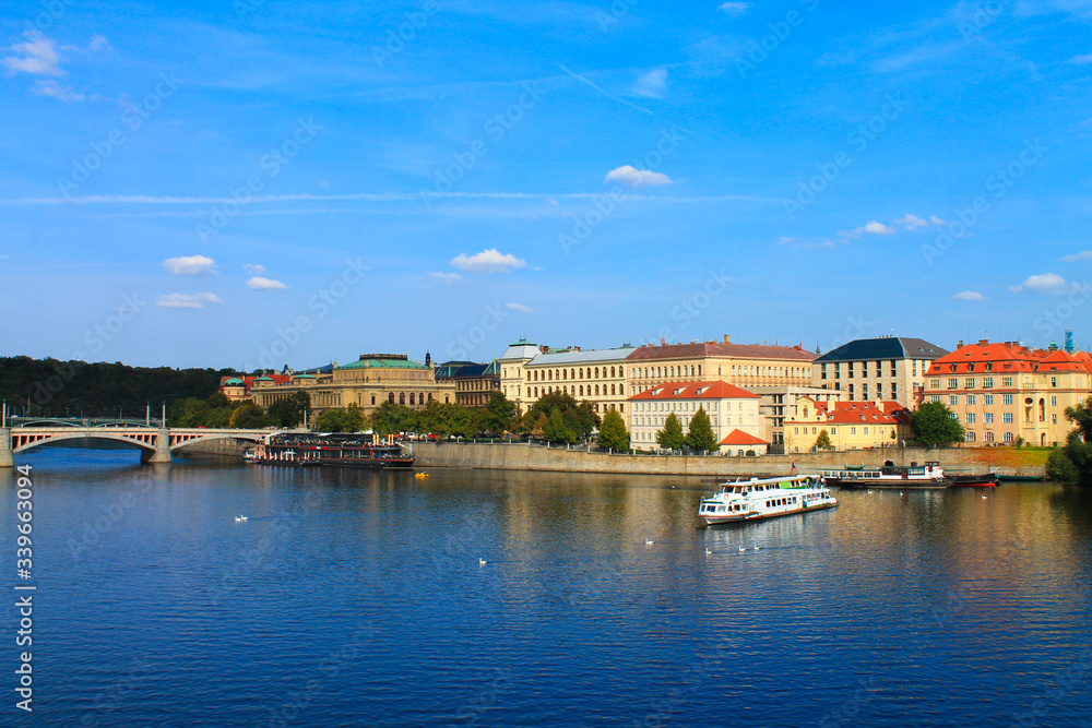 View of the Vltava river with a boat in the summer. Prague. Czech Republic