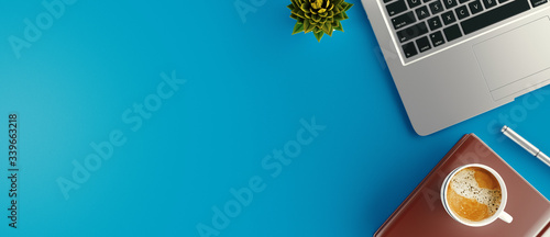 Minimal work space - Creative flat lay photo of workspace desk. Top view office desk with laptop, notebooks and coffee cup. 3d rendering banner