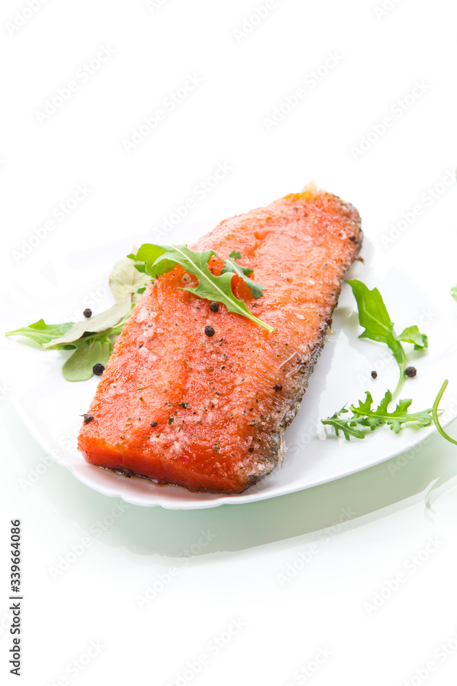 piece of salty red fish with different seasonings and herbs in a plate piece of salty red fish with different seasonings and herbs in a plate