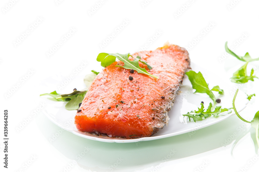 piece of salty red fish with different seasonings and herbs in a plate piece of salty red fish with different seasonings and herbs in a plate