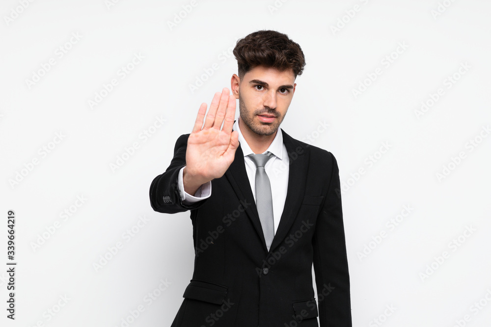 Young businessman over isolated white background making stop gesture with her hand Young businessman over isolated white background making stop gesture with her hand