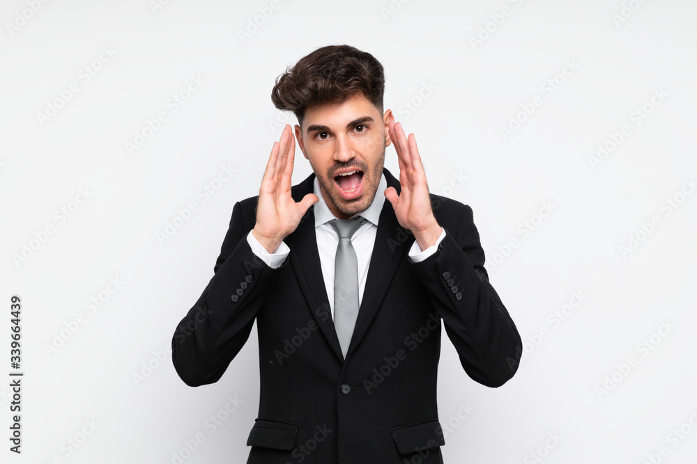 Young businessman over isolated white background shouting with mouth wide open Young businessman over isolated white background shouting with mouth wide open