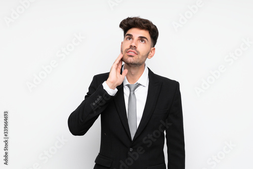 Young businessman over isolated white background thinking an idea