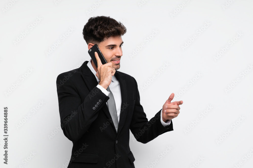 Young businessman with mobile phone over isolated white background Young businessman with mobile phone over isolated white background