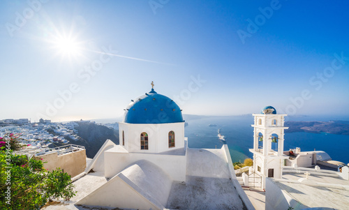 A blue domed church with bell tower in Imerovigli village, Santorini, Greece