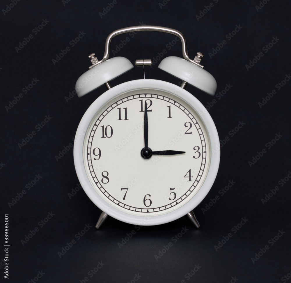 Old-style alarm clock, black and white, it's three o'clock. Old-style alarm clock, black and white, it's three o'clock.