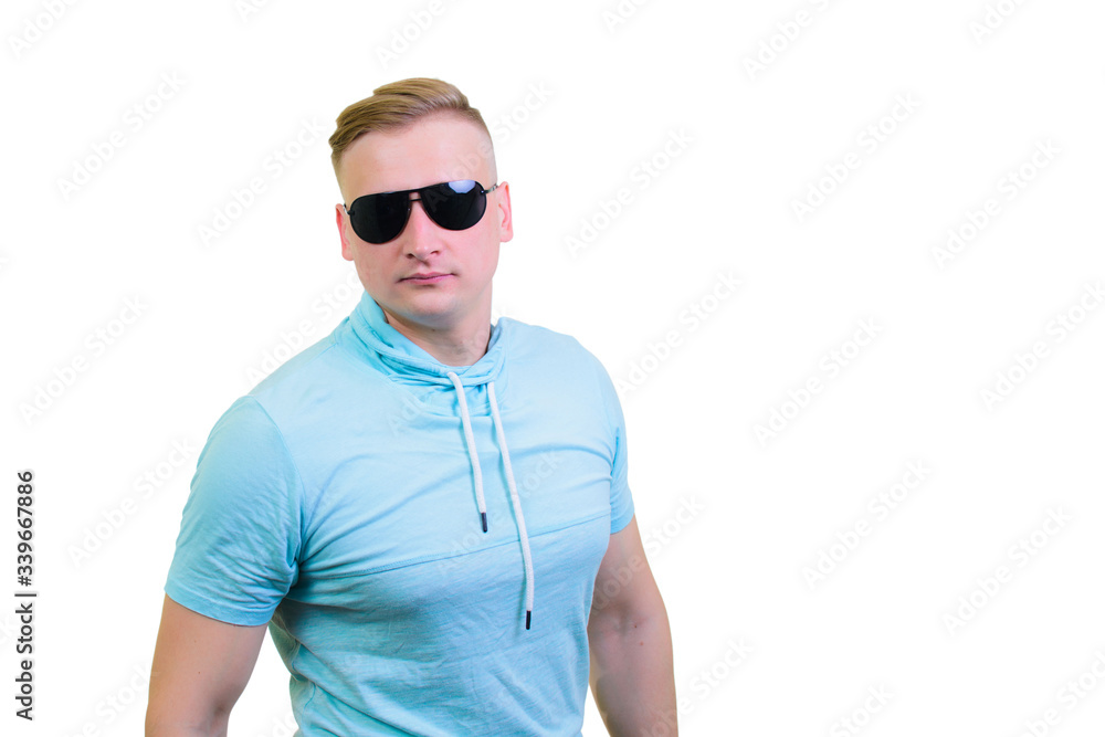 Portrait of a cheerful young guy standing in sunglasses Portrait of a cheerful young guy standing in sunglasses
