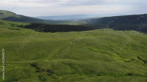 Aerial view, green valley, forest and hills in Adygea. Top View. Russia. 