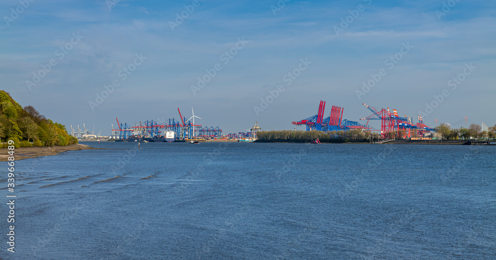Fototapeta premium Hamburg, Germany. The river Elbe and the port on a sunny spring afternoon.