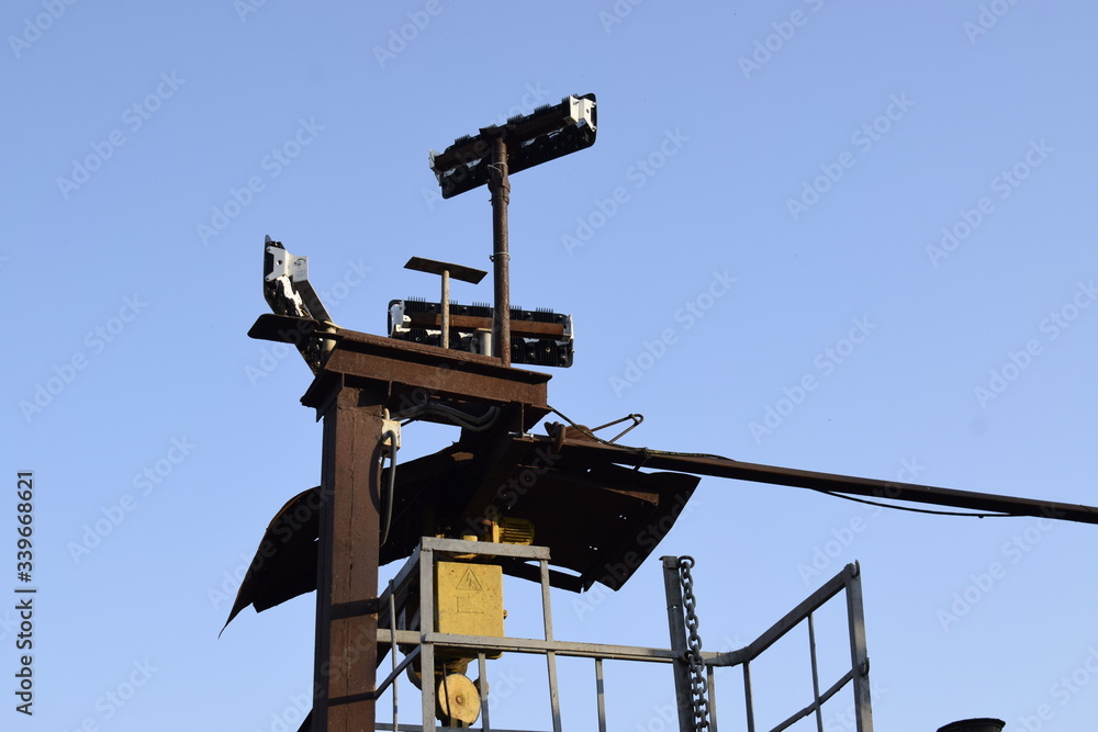 Spotlights on a metal structure against a blue sky. Spotlights on a metal structure against a blue sky.