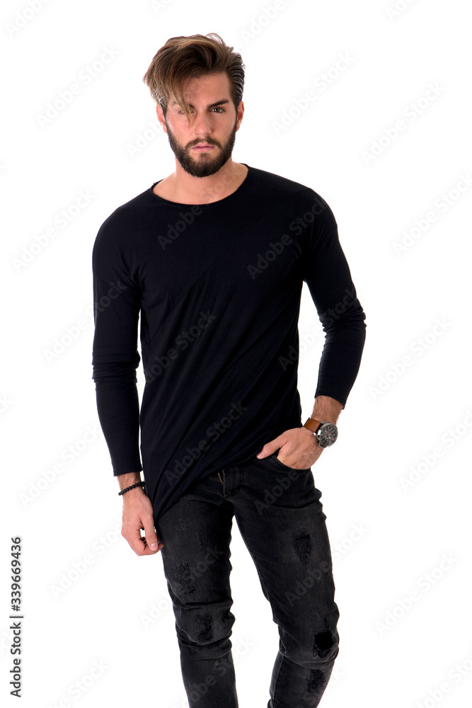 Three quarters shot of handsome young man with black shirt, looking at camera, on light background Three quarters shot of handsome young man with black shirt, looking at camera, on light background