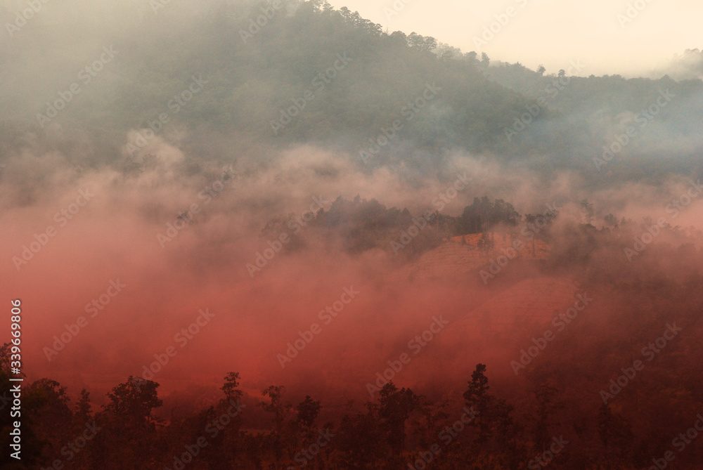 View landscape with silhouettes of mountains range with mist or covered by heavy fog View landscape with silhouettes of mountains range with mist or covered by heavy fog