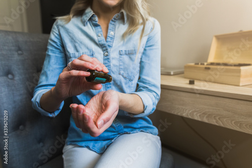 Photography Young woman applying essential oils to her wrist
