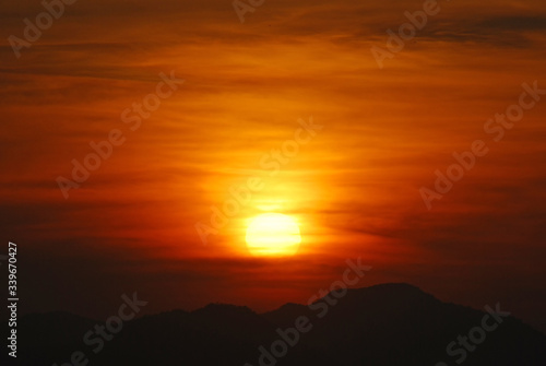 Sunrise among forests and mountains