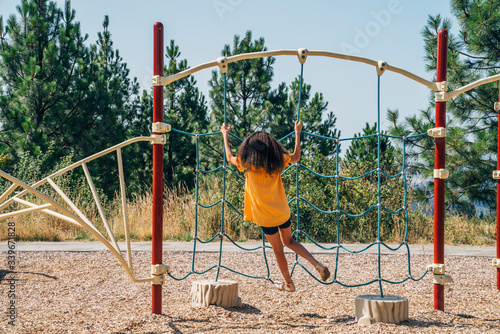 Girl playing in playground alone photo