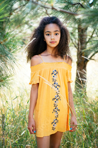 Portrait of girl in dress standing outdoors